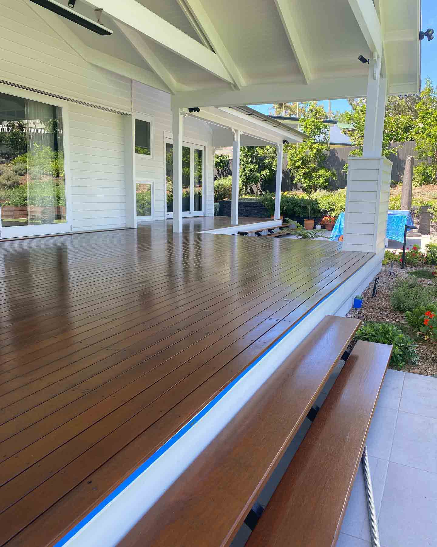 Long oiled timber verandah with masking tape along the edge above the steps