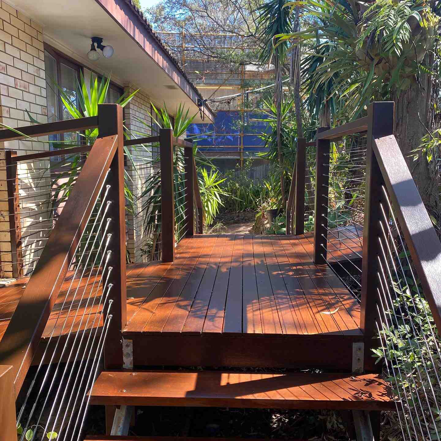 Oiled timber walkway deck with steps and timber and wire balustrade