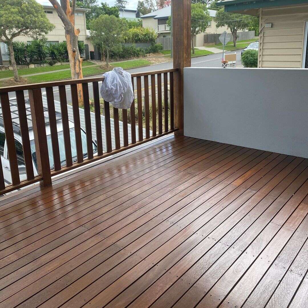 Oiled timber deck with timber balustrade overlooking a street