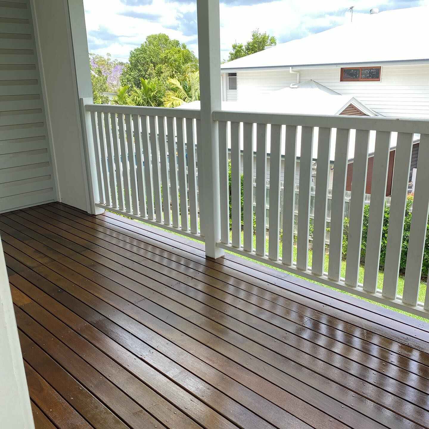 Oiled timber verandah with white timber balustrade, close view