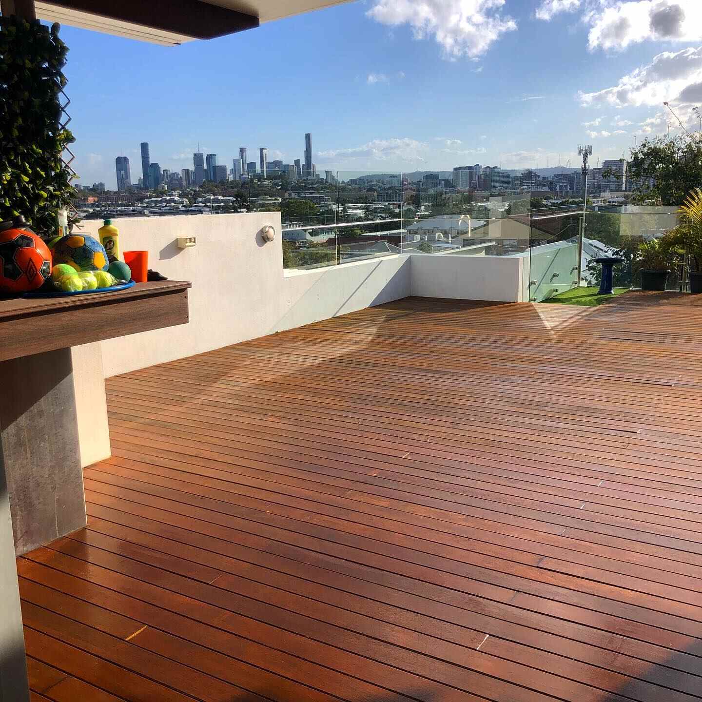 Oiled timber rooftop deck with a city skyline view