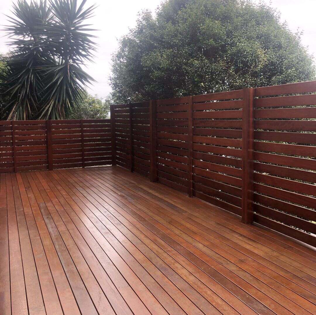 Oiled timber deck with a horizontal timber slat screen fence