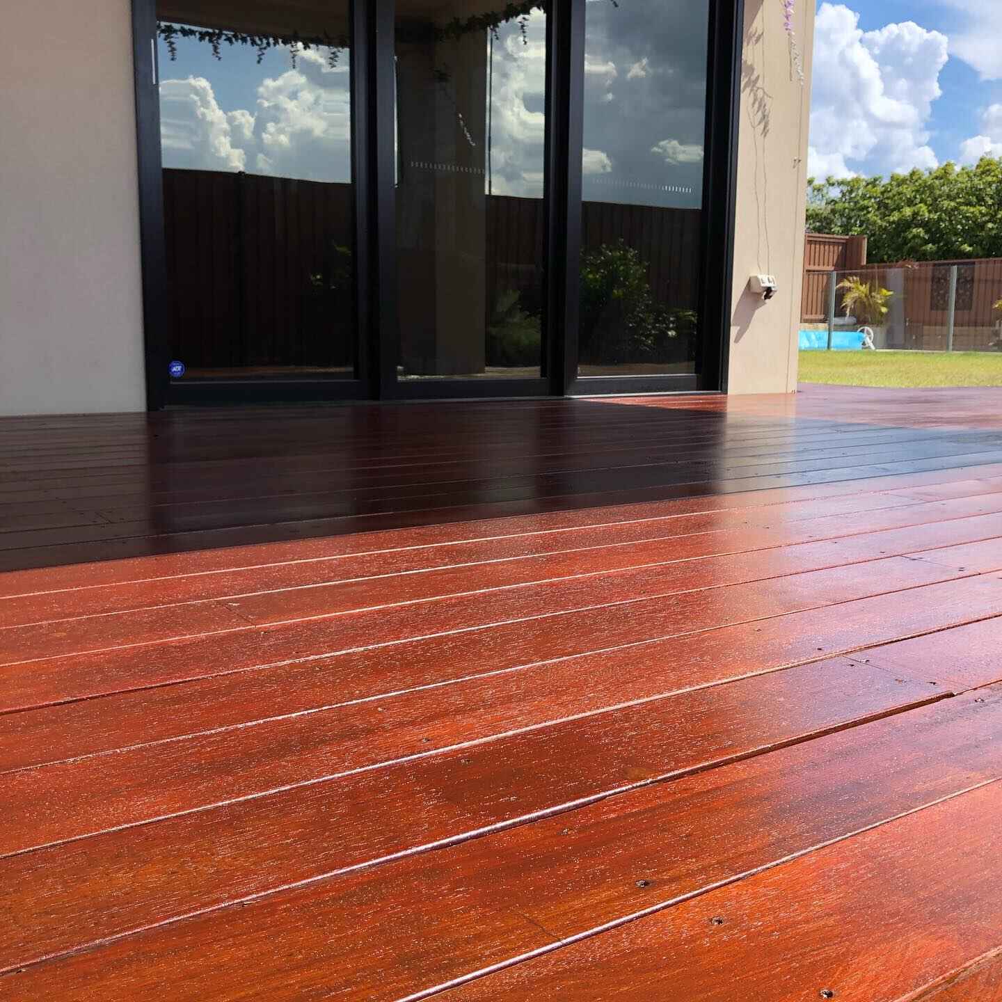 Close-up of glossy freshly oiled red-toned deck boards