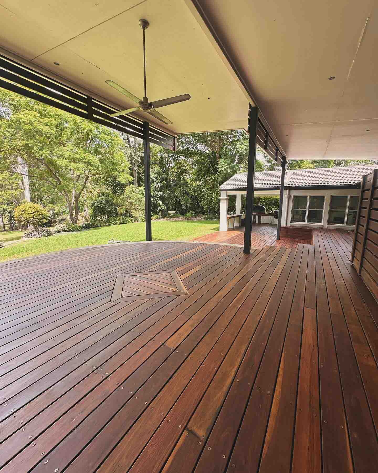 Same deck with the diamond inlay, looking out to the lawn and trees