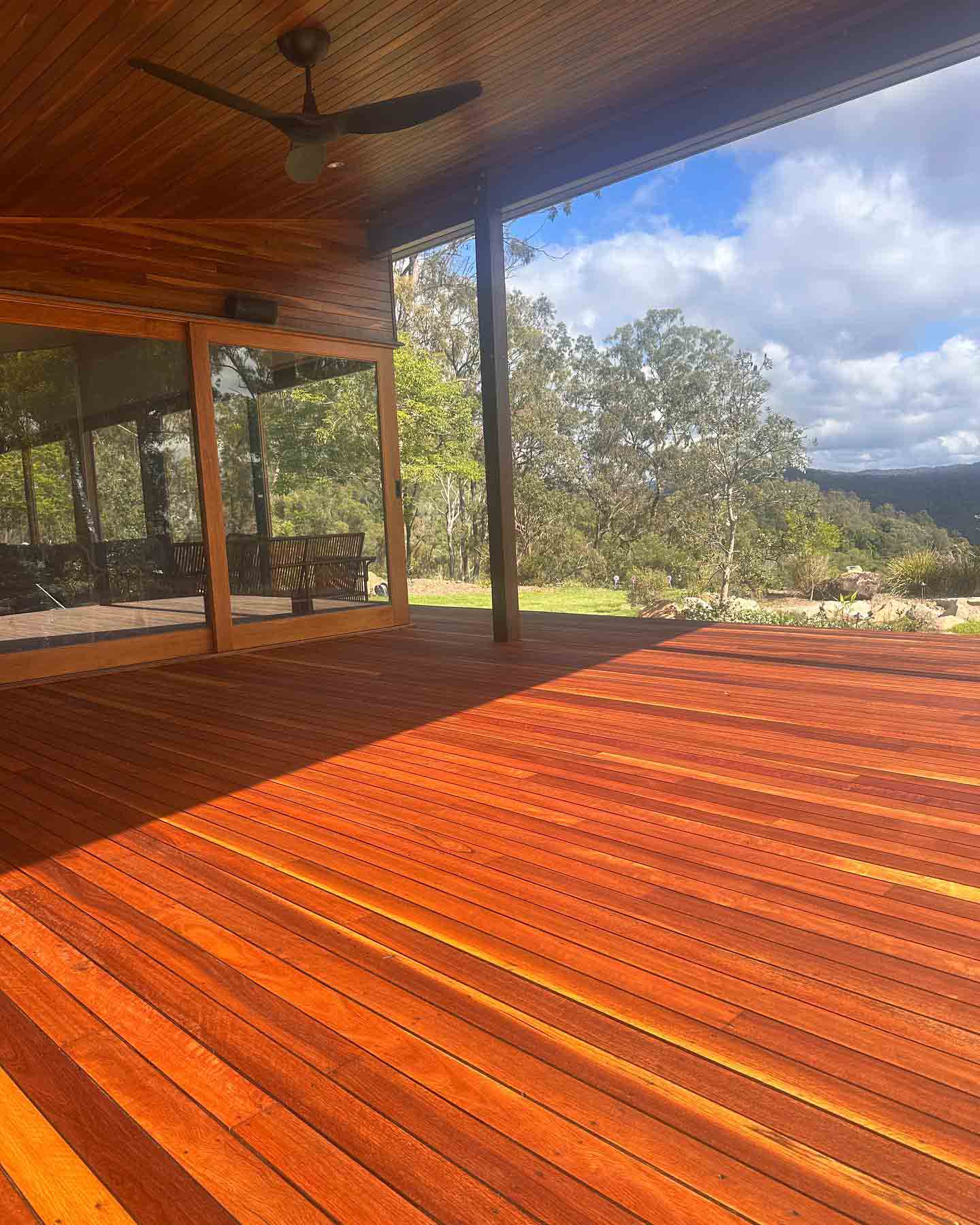 Covered oiled timber deck with views over bushland hills